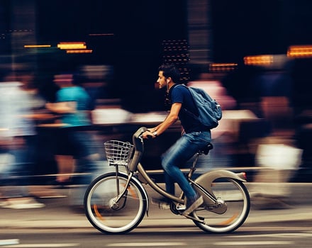 Person riding bicycle in focus