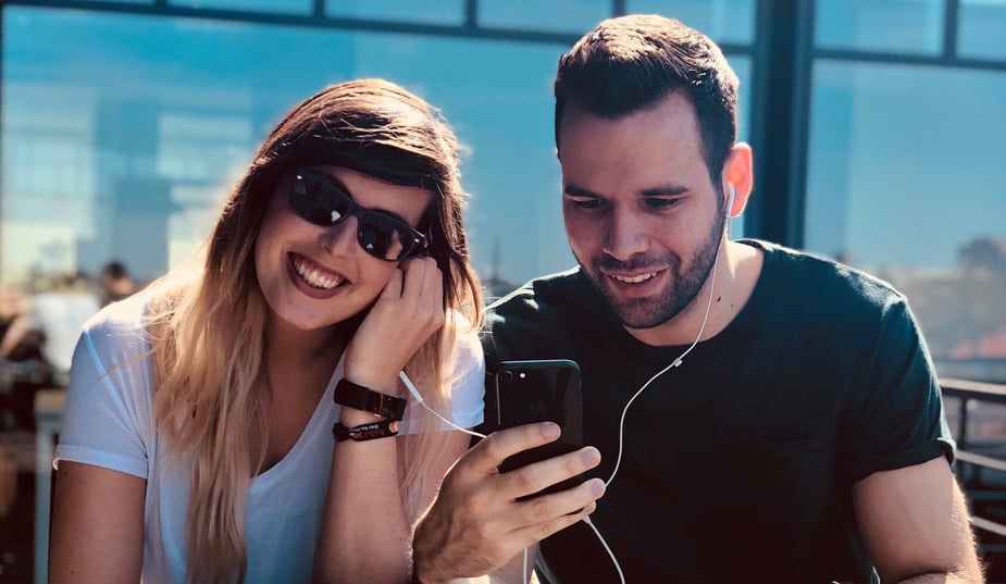two people listening to music from a mobile device